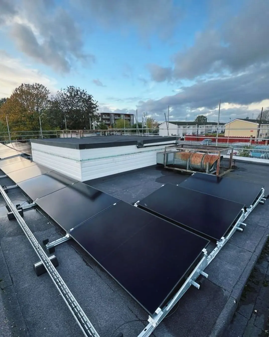 Flat rooftop solar panel installation with metal frames